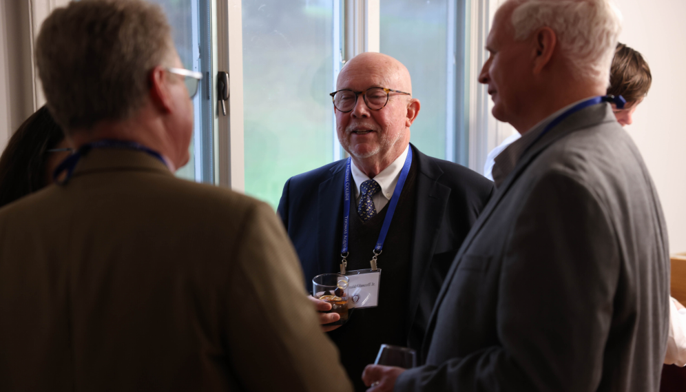 Mr. Cain speaks with some alumni