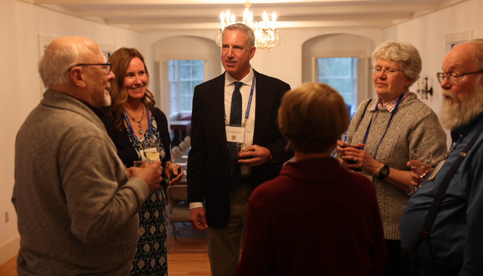 Mr. Powell speaks with other alumni