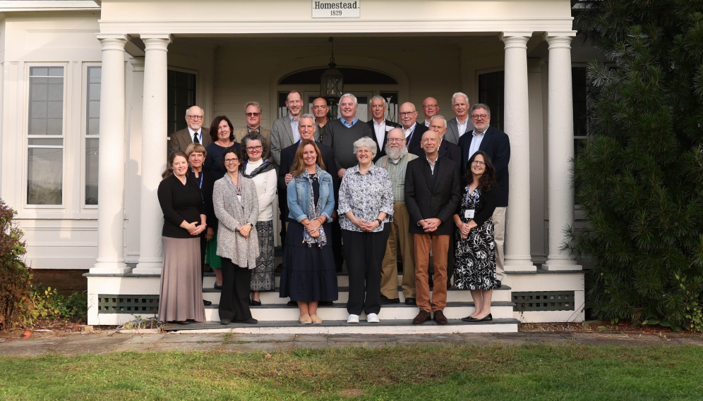 College friends get together for a photograph in front of the moody homestead