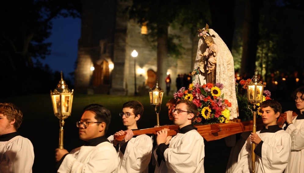 The procession reaches the bottom of the hill