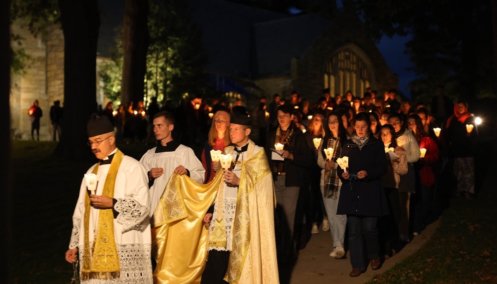 The procession reaches the bottom of the hill