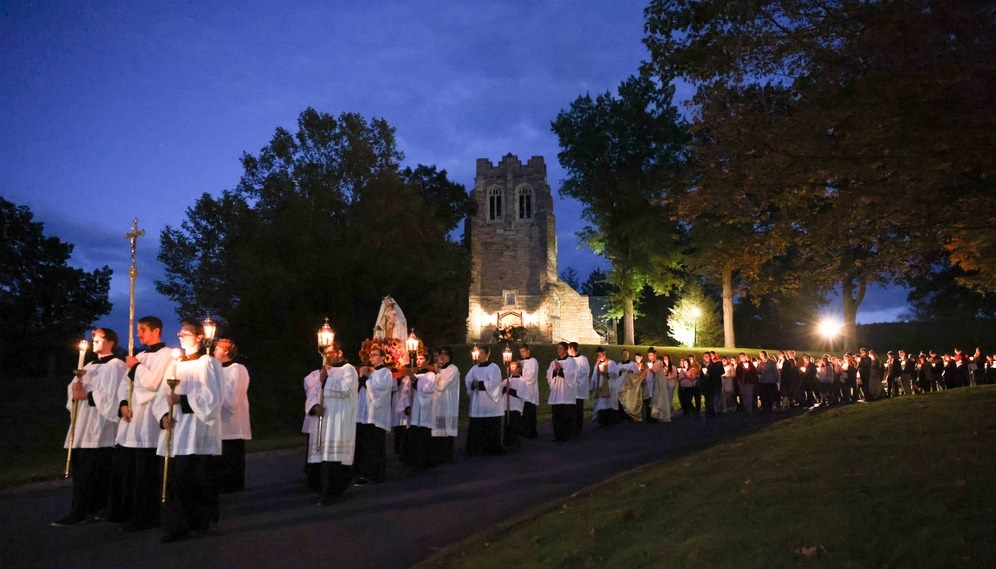 The procession reaches the bottom of the hill