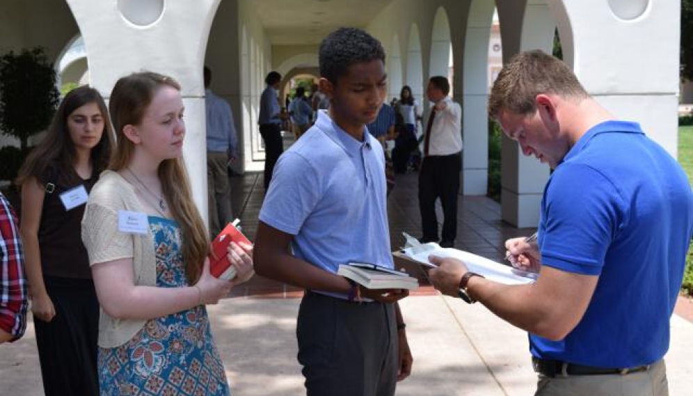 Students get their ID photos and submit t-shirt sizes (High 