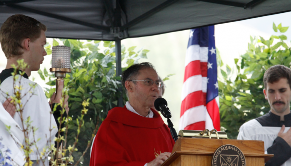 Head Chaplain Rev. Paul Raftery, O.P.. proclaims the Gospel