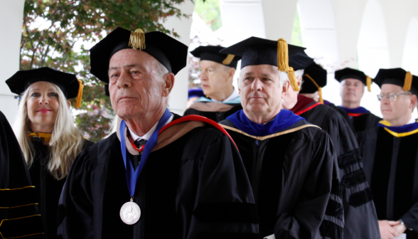 Members of the Board of Governors recess from the academic quadrangle