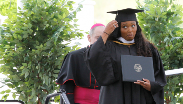 A graduate ceremoniously tosses her tassel 