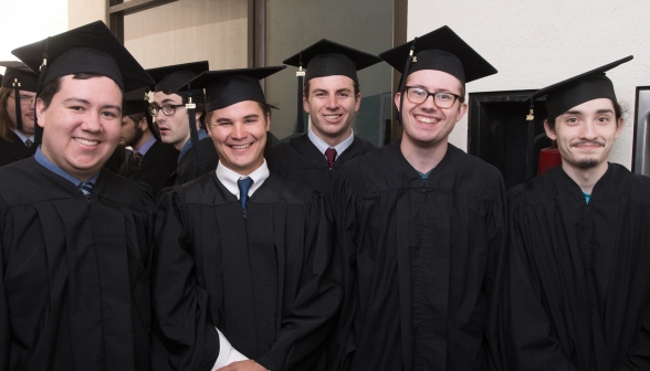 Five students in graduating robes