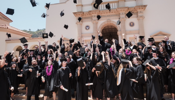 The graduates throw their hats on the steps of the Chapel