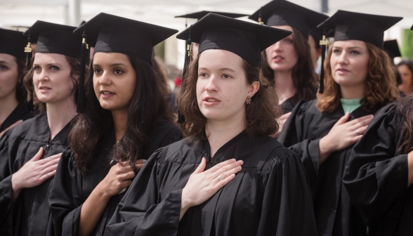 The graduates recite the Pledge of Allegiance