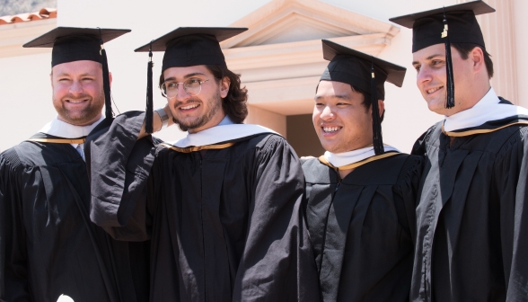 Happy graduates pose for a photo