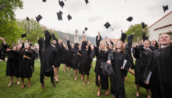 The graduates throw their caps aloft