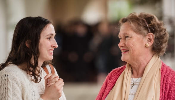 A graduate chats with Mrs. Grimm