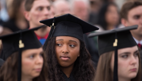 Closeup of a graduate amongst her classmates
