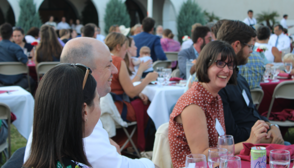 Alumni laughing at their table