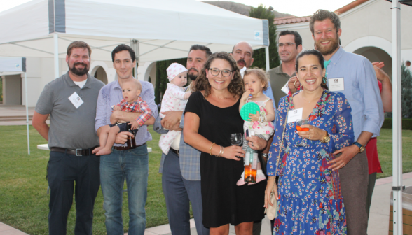 Alumni pose for a photo, some with babies in arms