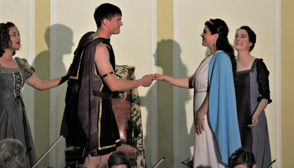 Aeneas holds Dido's hand