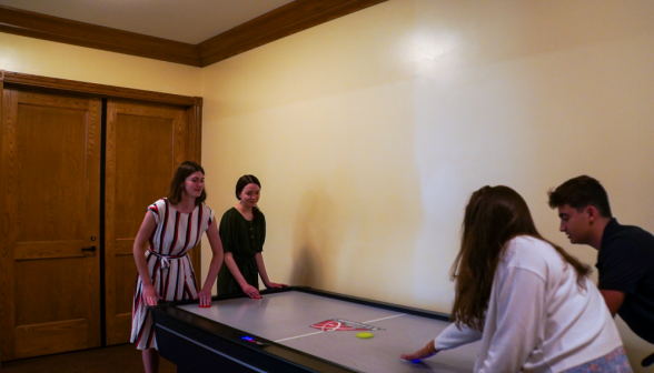 Students play air hockey