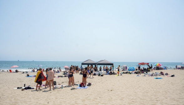Long shot of the beach and ocean: busy, but not too crowded
