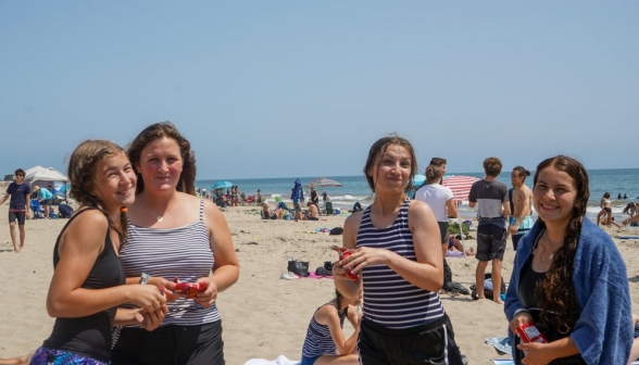 Cheetos in hand, four girls smile at the camera