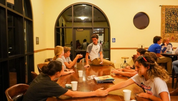 Card games all down the big table at the coffee shop