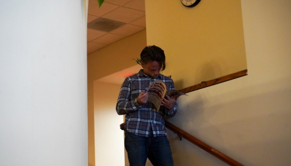 A graduate prefect peruses TIME Magazine.