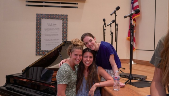 Three girls afront the piano