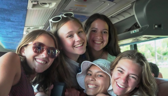 Students squeeze together to fit in frame in the bus