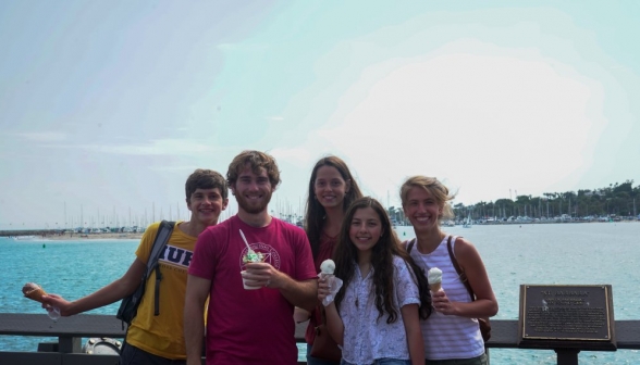 Five with icecream, afront a harbor with boats at anchor