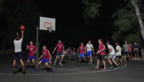 A student attempts a shot from behind the three-point line!