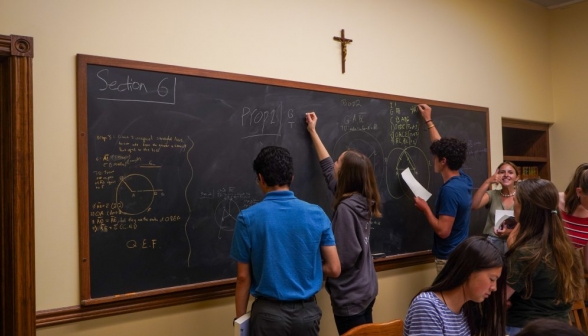 Three students practice Prop 2 simultaneously on different sections of the board