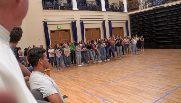 The students are separated into guys and girls, on opposite sides of the floor