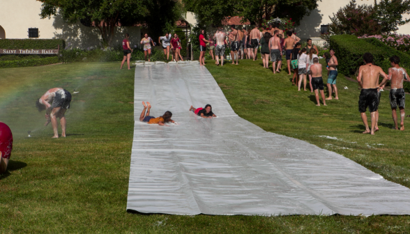 Two students going down in the "Superman" position