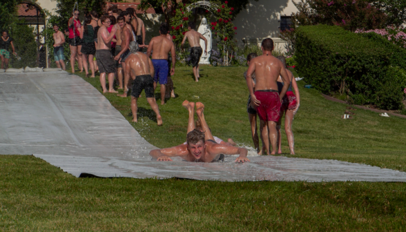 A student does down the slide, headfirst at high speeds