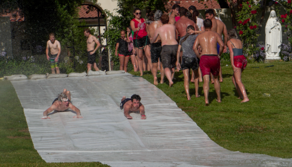 Two students "Superman" down the slide