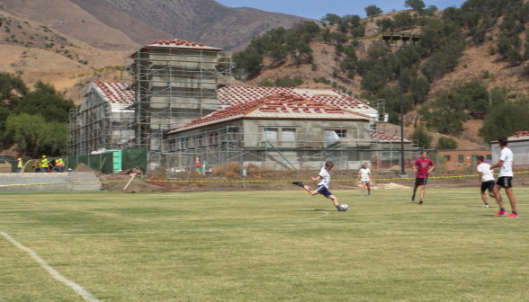 A student aims a shot at the goal