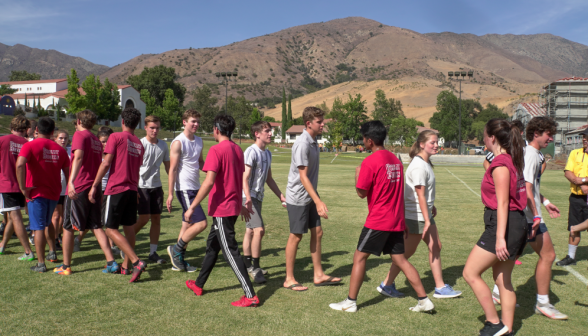 Students and prefects pass one another in the traditional post-game handshake