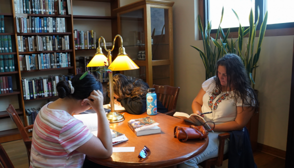 Two students study at a corner table