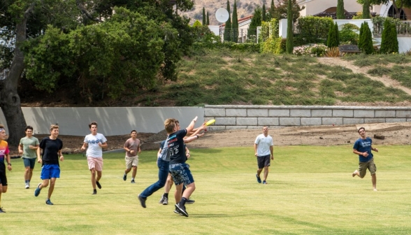 Two fighting to catch the frisbee first