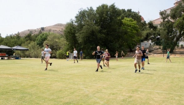 Students run on the field