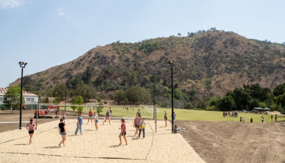 Long shot of the entire field, with soccer and volleyball both visible, from the patio