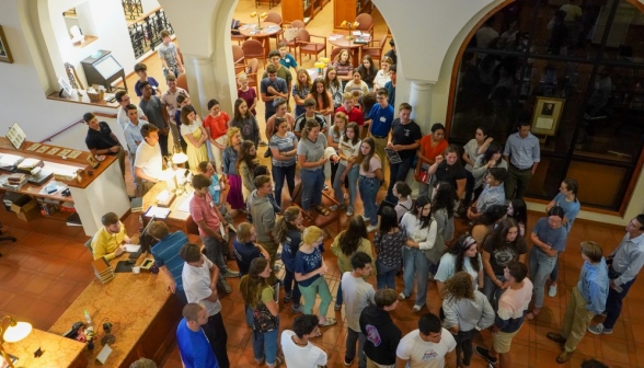 The students crowd around in preparation for study hour