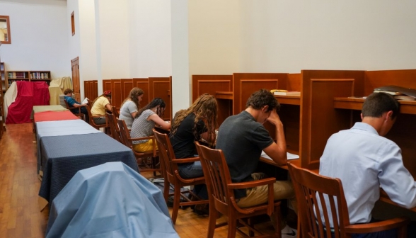 Students seated in rows in the library, studying