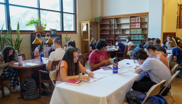 Students study at constructed tables