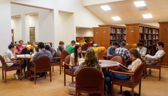 Students gathered at the tables on the right side of the library