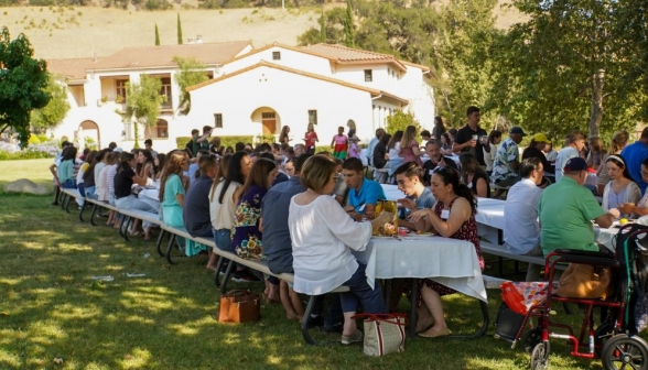 Students and parents pack the tables and eat the BBQ meal