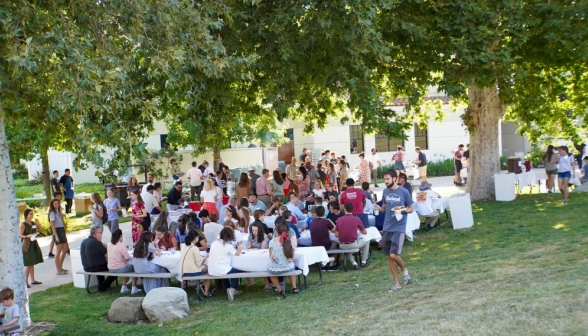 Long shot of people eating at the tables