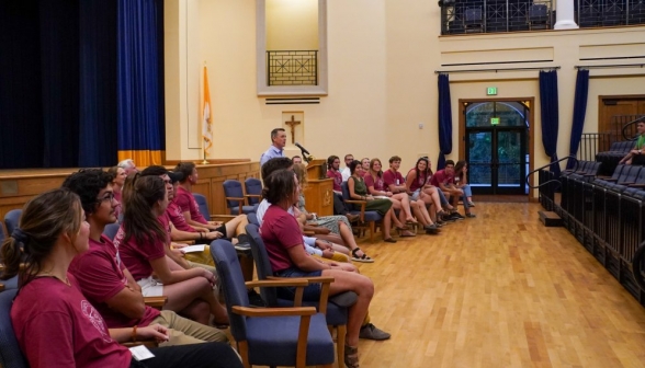 Jon Daly delivers the orientation speech, flanked by prefects