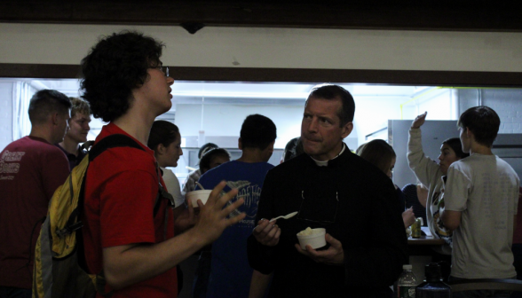 Father Markey chats with a student over ice cream