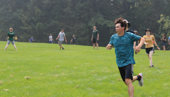 A student running across the field