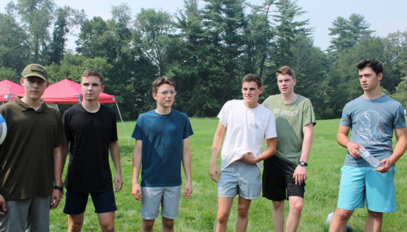 A row of students afront the treeline